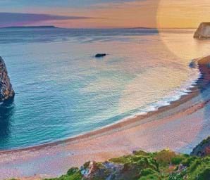 calm sea and golden sand in durdle door dorset uk