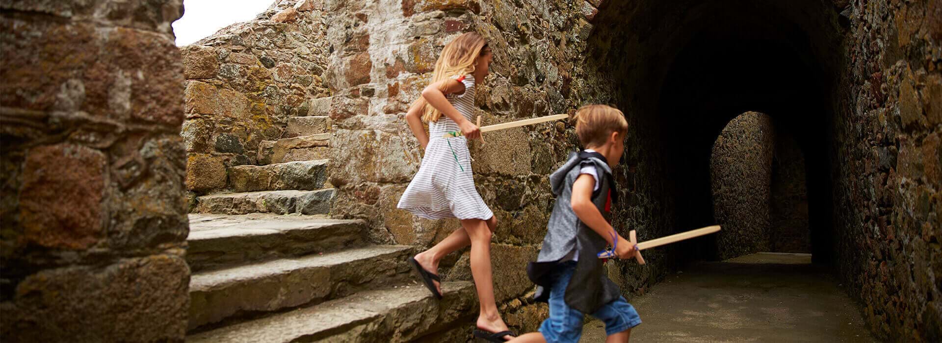 two children playing at castle cornet in guernsey