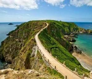 view of country road in sark with blue sky in the background