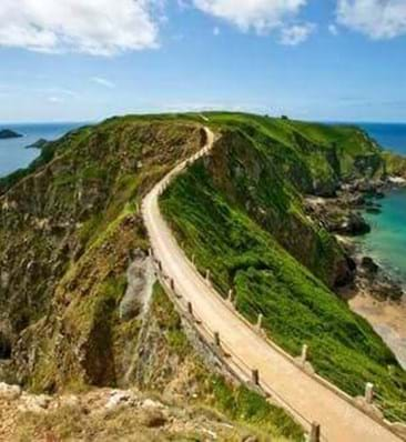 view of country road in sark with blue sky in the background