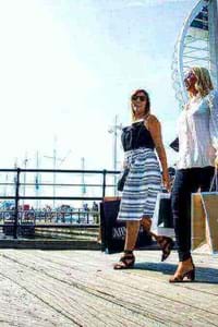 couple walking through gunwharf quays shopping centre portsmouth