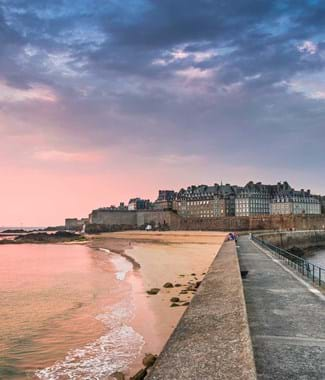 view of st malo walls in brittany with pink sky