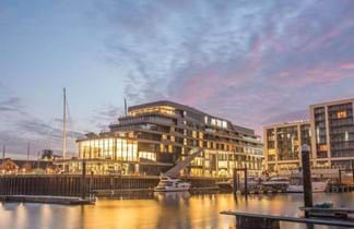 southampton harbour hotel with large lights and pink skies in the uk
