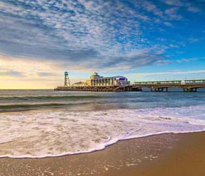 view of bournemouth pier dorset with blue skies and clear seas