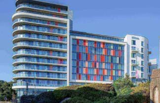hilton hotel bournemouth with colourful windows and blue sky background