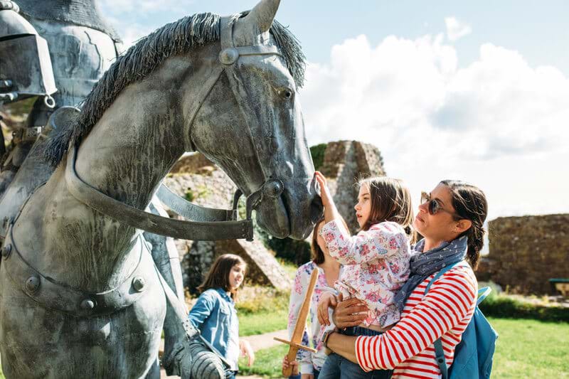 children looking at horse statue mont orgueil jersey channel island