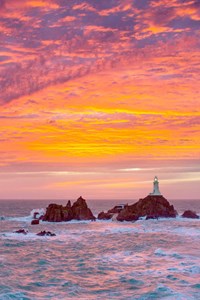 jersey corbiere lighthouse with orange pink sky