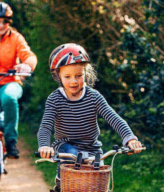 little girl cycling with family behind on cycle path
