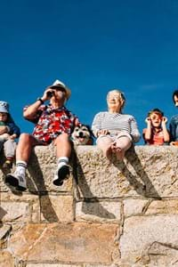 group of friends sitting in st malo looking over blue sea