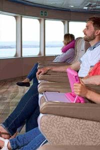 family sitting in the front seats looking at the view in horizon lounge condor