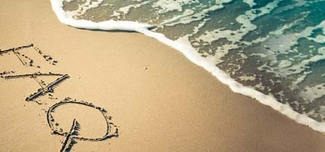 FAQ written in sand with sea